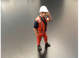 Figure - Pascal has a headache.Orange safety jacket with helmet